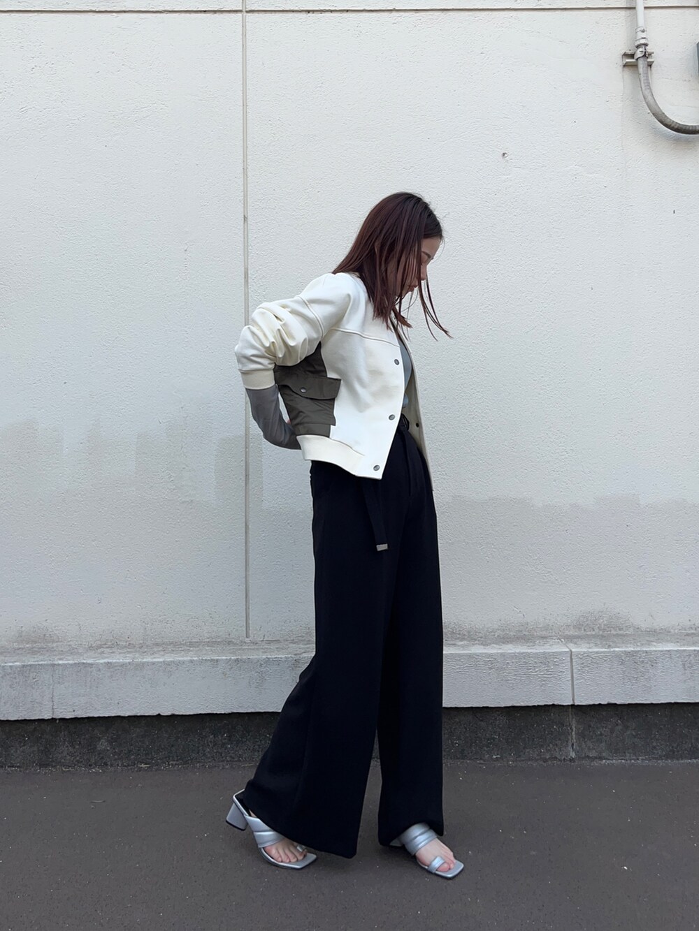 ホワイト系のブルゾン、グリーン系のTシャツ/カットソー、ブラック系のスラックスを着用したレディースの春コーディネートの3枚目の写真