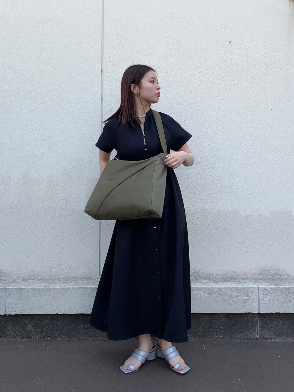 ブラック系のワンピース、グリーン系のトートバッグを着用したレディースの春コーディネートの3枚目の写真