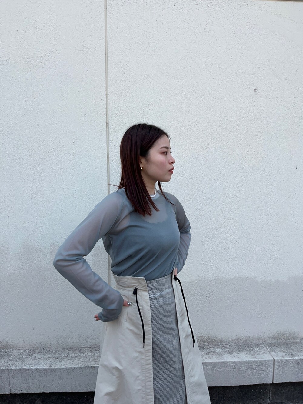 グリーン系のTシャツ/カットソー、ベージュ系のスカートを着用したレディースの春コーディネートの5枚目の写真