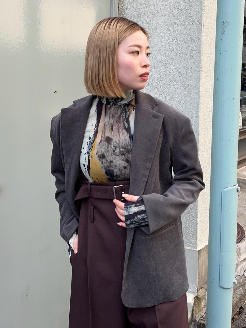 ブルー系のTシャツ/カットソー、グレー系のテーラードジャケット、ブラック系のブーツを着用したレディースの冬コーディネートの6枚目の写真