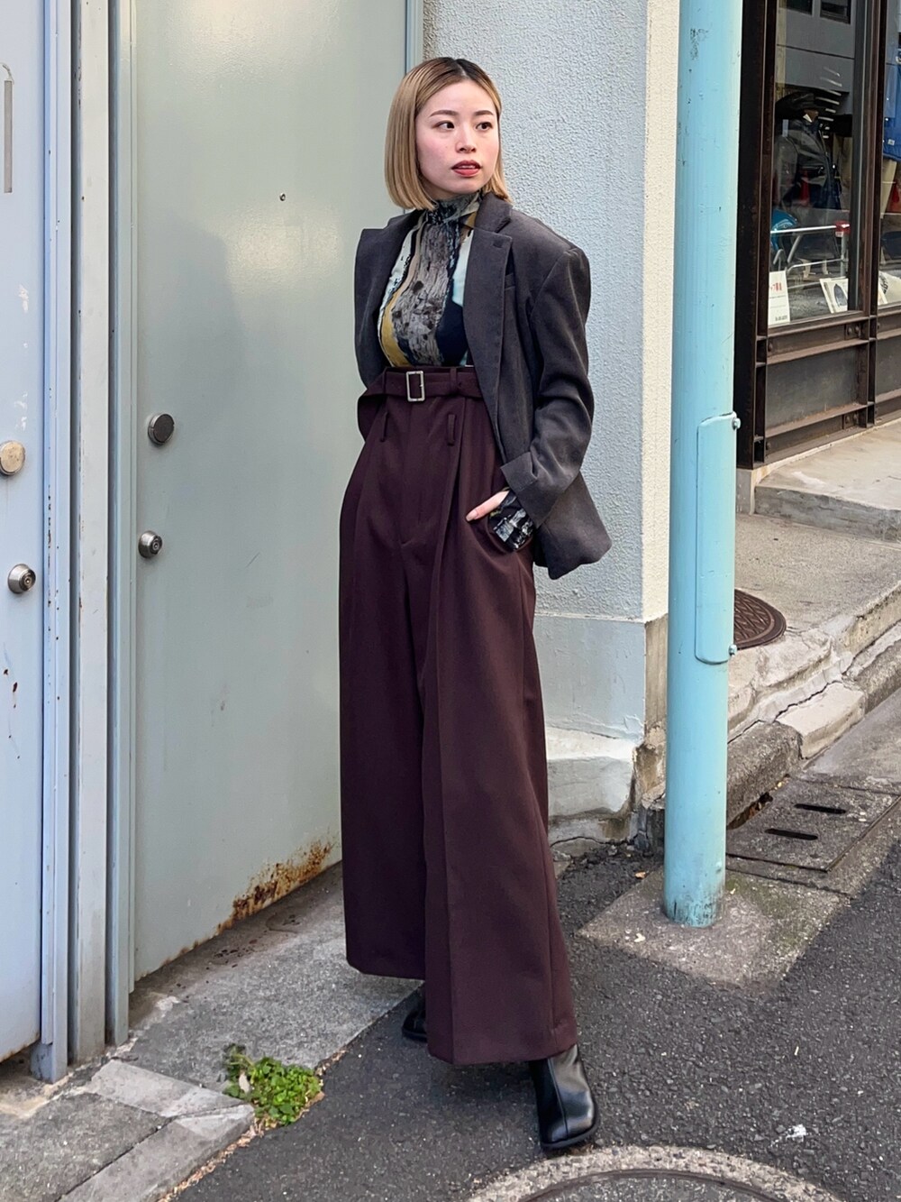 ブルー系のTシャツ/カットソー、グレー系のテーラードジャケット、ブラック系のブーツを着用したレディースの冬コーディネートの2枚目の写真