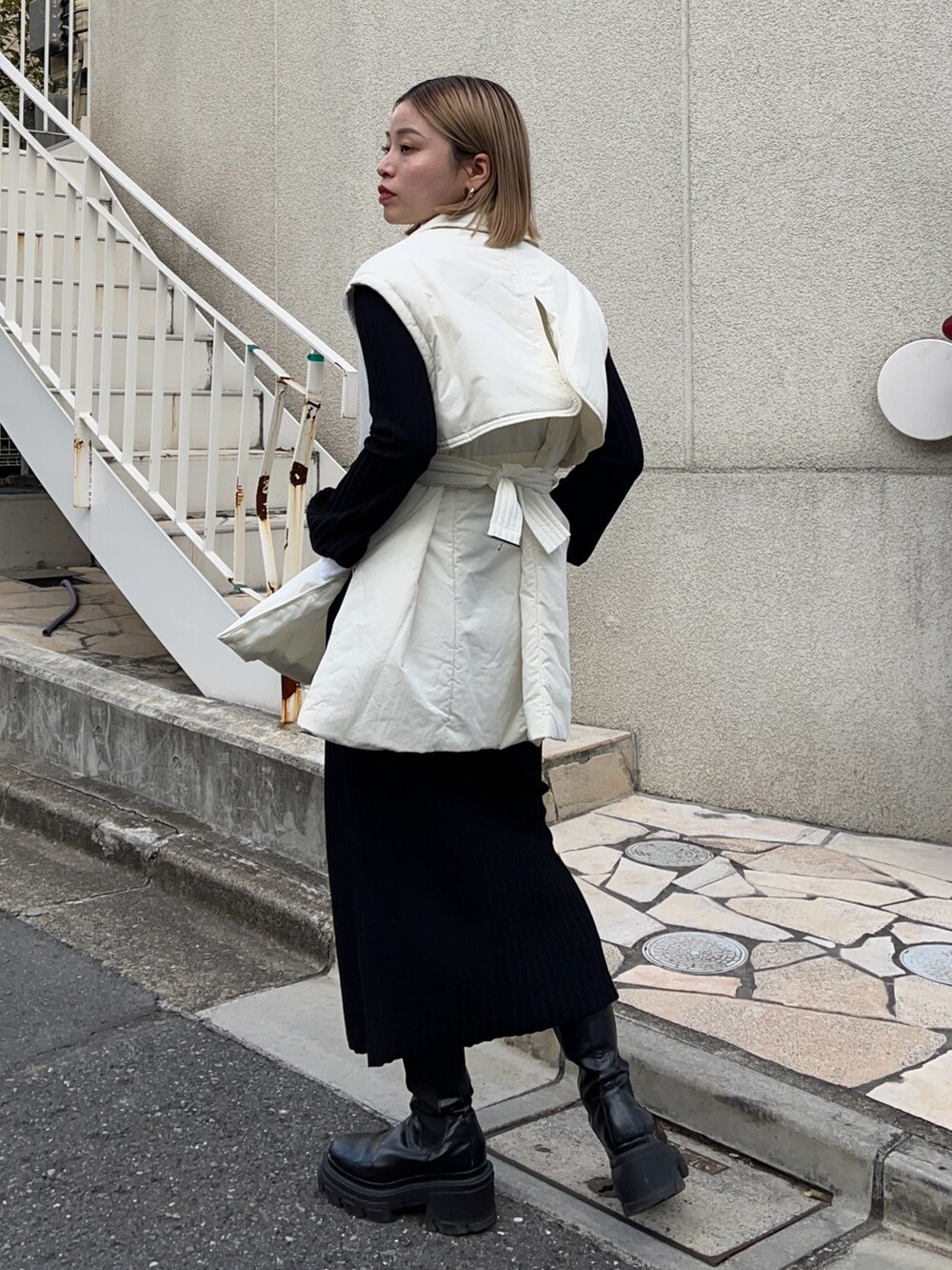 ブラック系のワンピース、ホワイト系のダウンジャケット/コートを着用したレディースの冬コーディネートの3枚目の写真