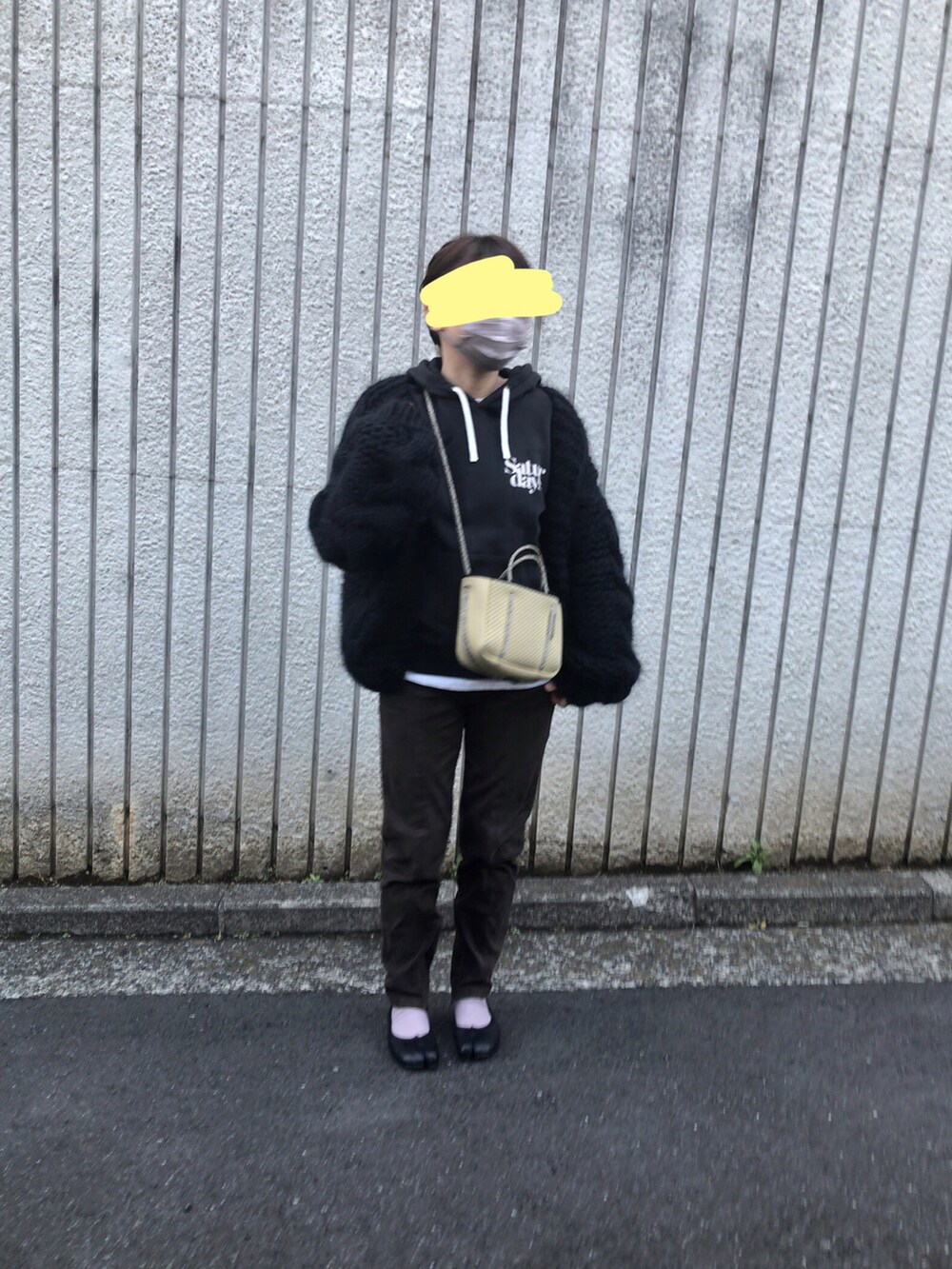 ブラウン系のパンツ、イエロー系のバッグ、ブラック系のバレエシューズを着用したレディースの冬コーディネートの2枚目の写真