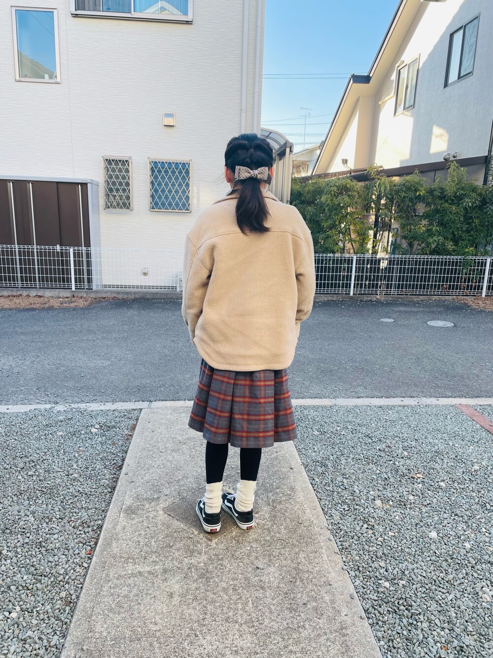 ベージュ系のその他アウター、レッド系のスウェット、グレー系のスカートを着用したキッズの冬コーディネートの2枚目の写真