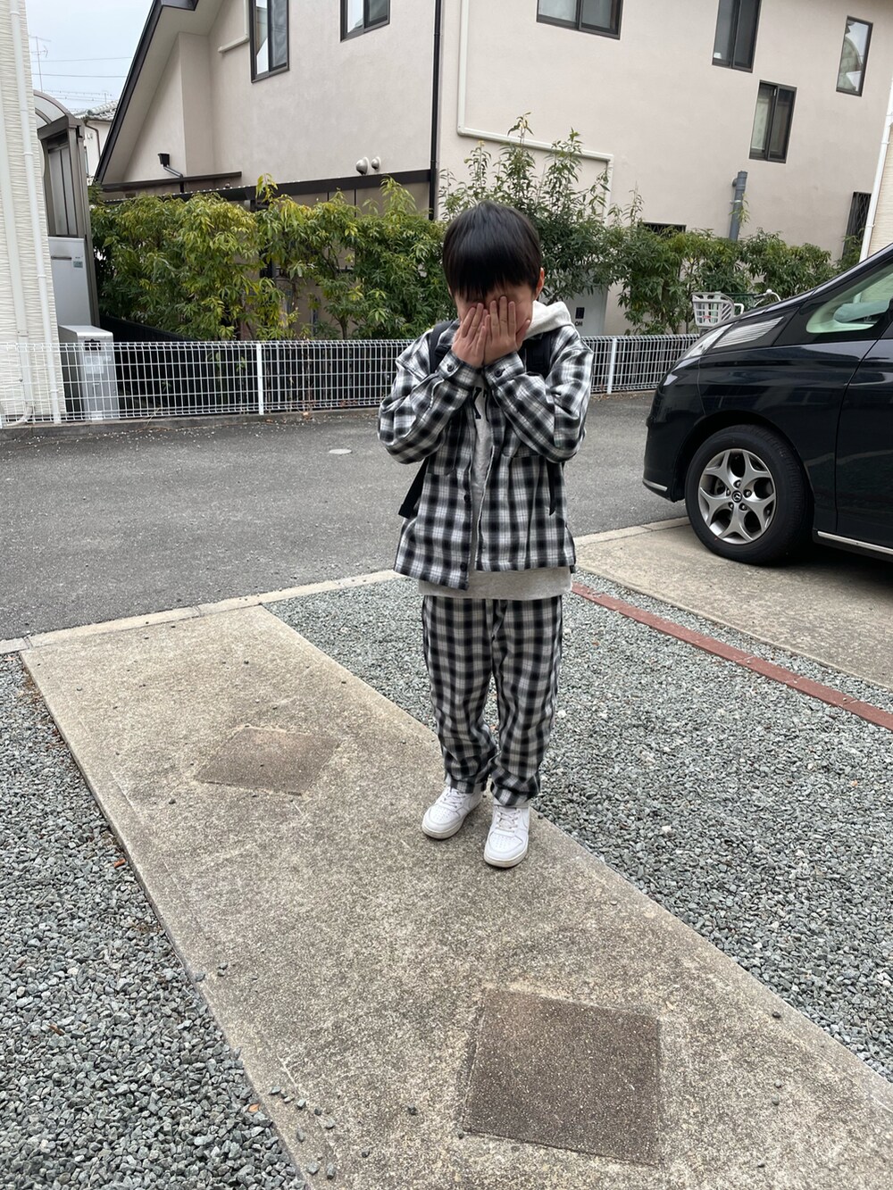 ブラック系のバックパック/リュック、グレー系のTシャツ/カットソー、ホワイト系のスニーカーを着用したキッズの冬コーディネートの4枚目の写真