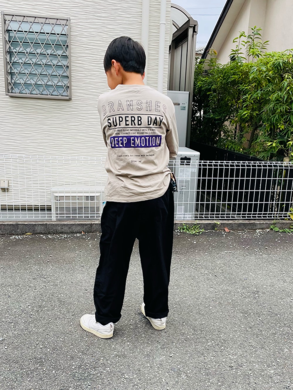 ブラック系のその他パンツ、ホワイト系のスニーカー、ベージュ系のTシャツ/カットソーを着用したキッズの秋コーディネートの4枚目の写真