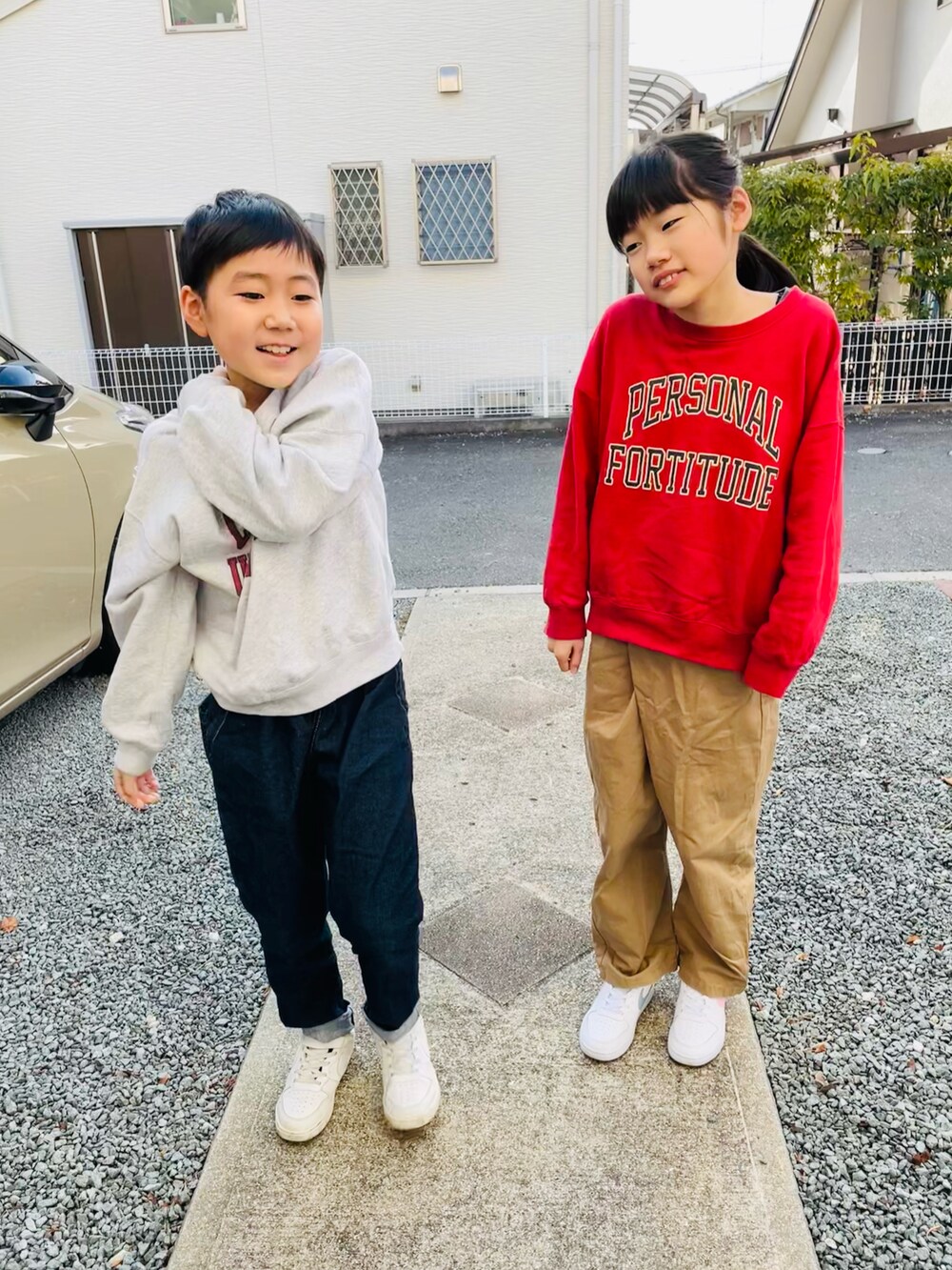 グレー系のスウェット、ブルー系のデニムパンツ、ホワイト系のスニーカーを着用したキッズの冬コーディネートの3枚目の写真