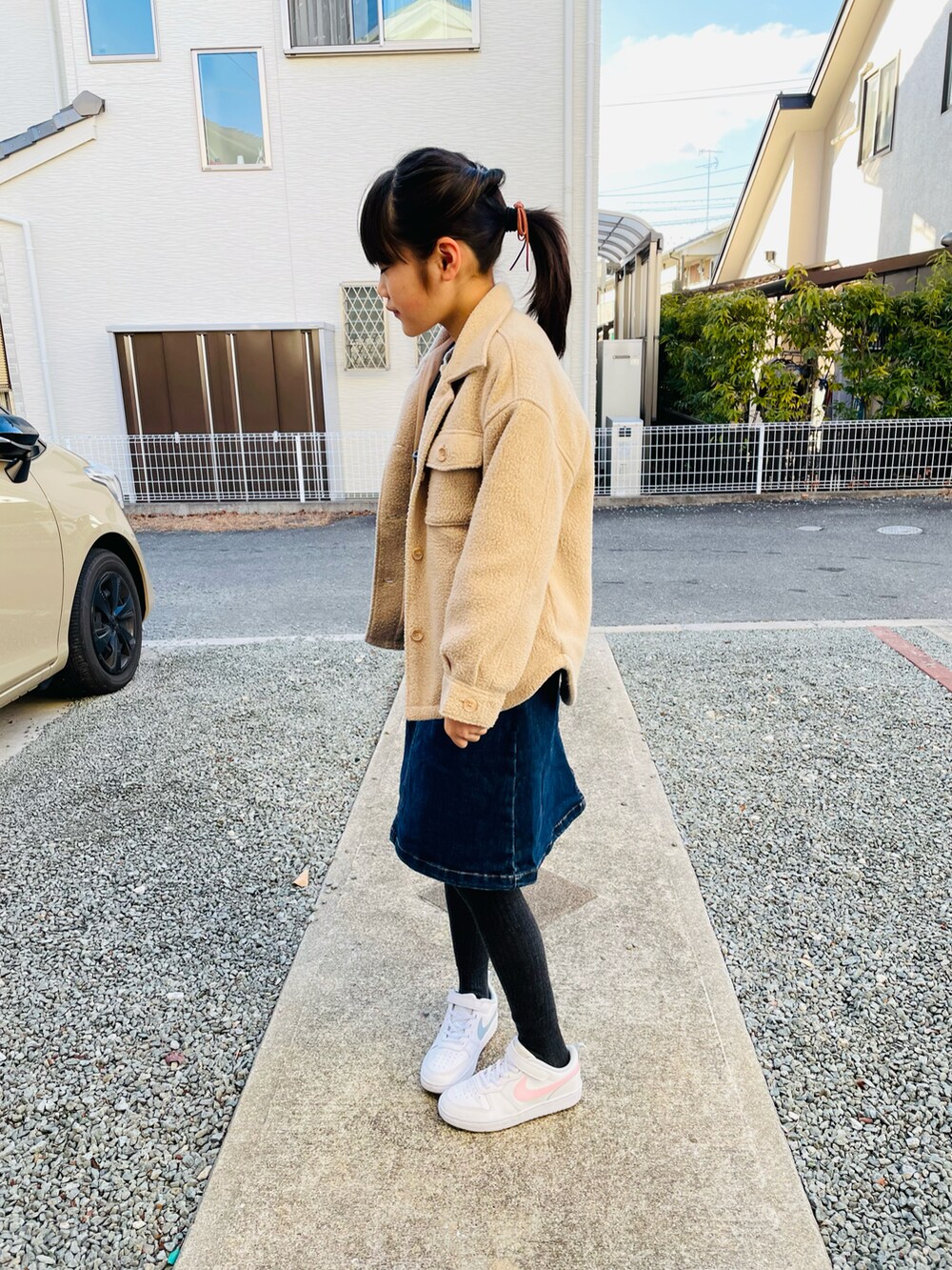 ベージュ系のその他アウター、ブルー系のスカート、ホワイト系のスニーカーを着用したキッズの春コーディネートの2枚目の写真