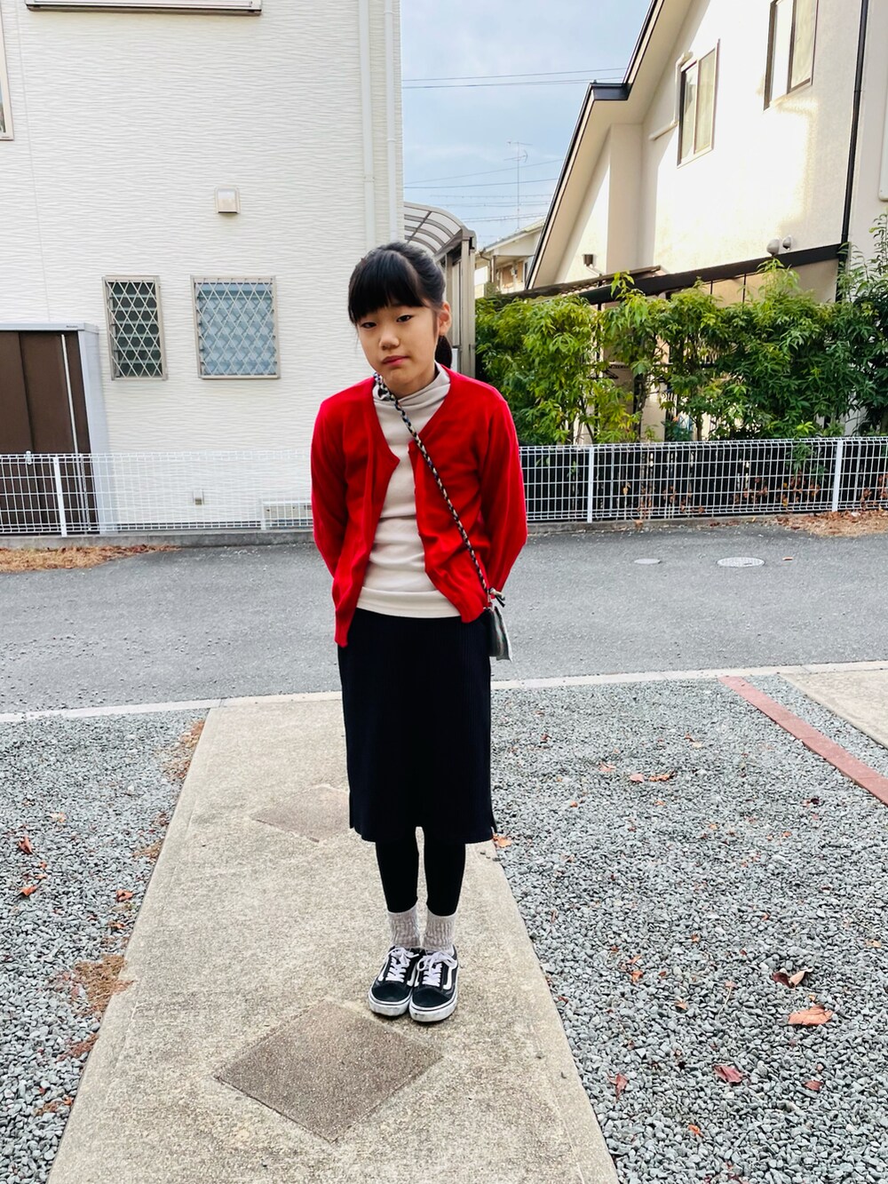 ブラック系のブルゾン、ブラック系のスカート、ブラック系のスニーカーを着用したキッズの冬コーディネートの4枚目の写真