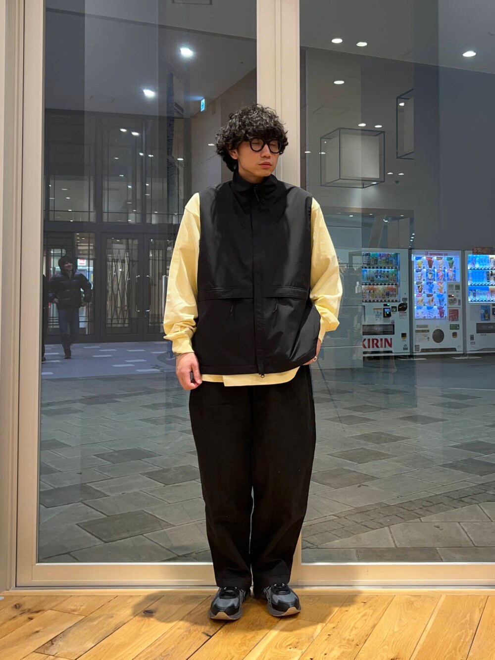 ブラック系のデニムパンツ、ブラック系のその他アウター、その他のTシャツ/カットソーを着用したメンズの冬コーディネートの4枚目の写真