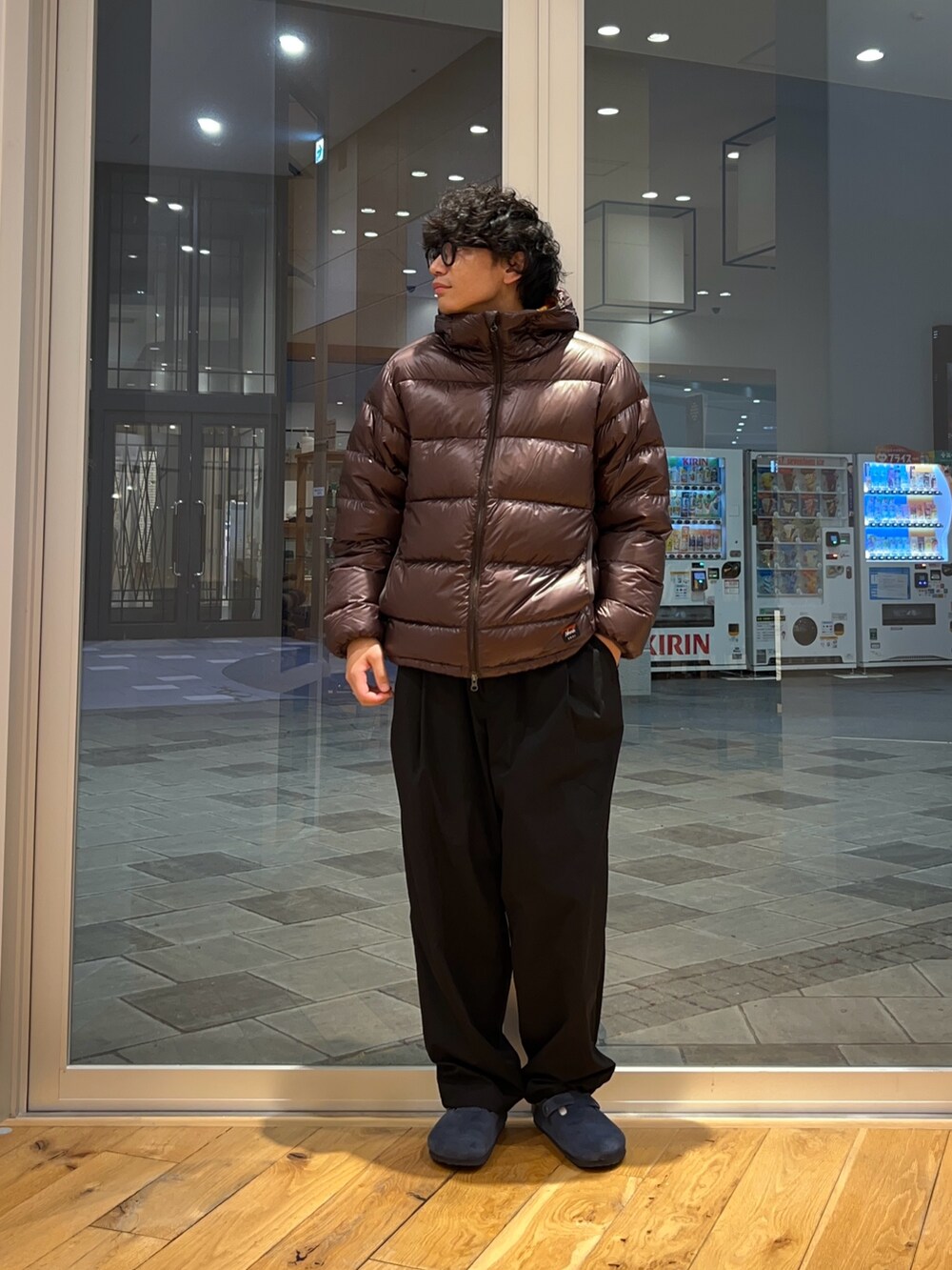 ブラウン系のダウンジャケット/コート、ブラック系のその他パンツ、グレー系のニット/セーターを着用したメンズの秋コーディネートの3枚目の写真