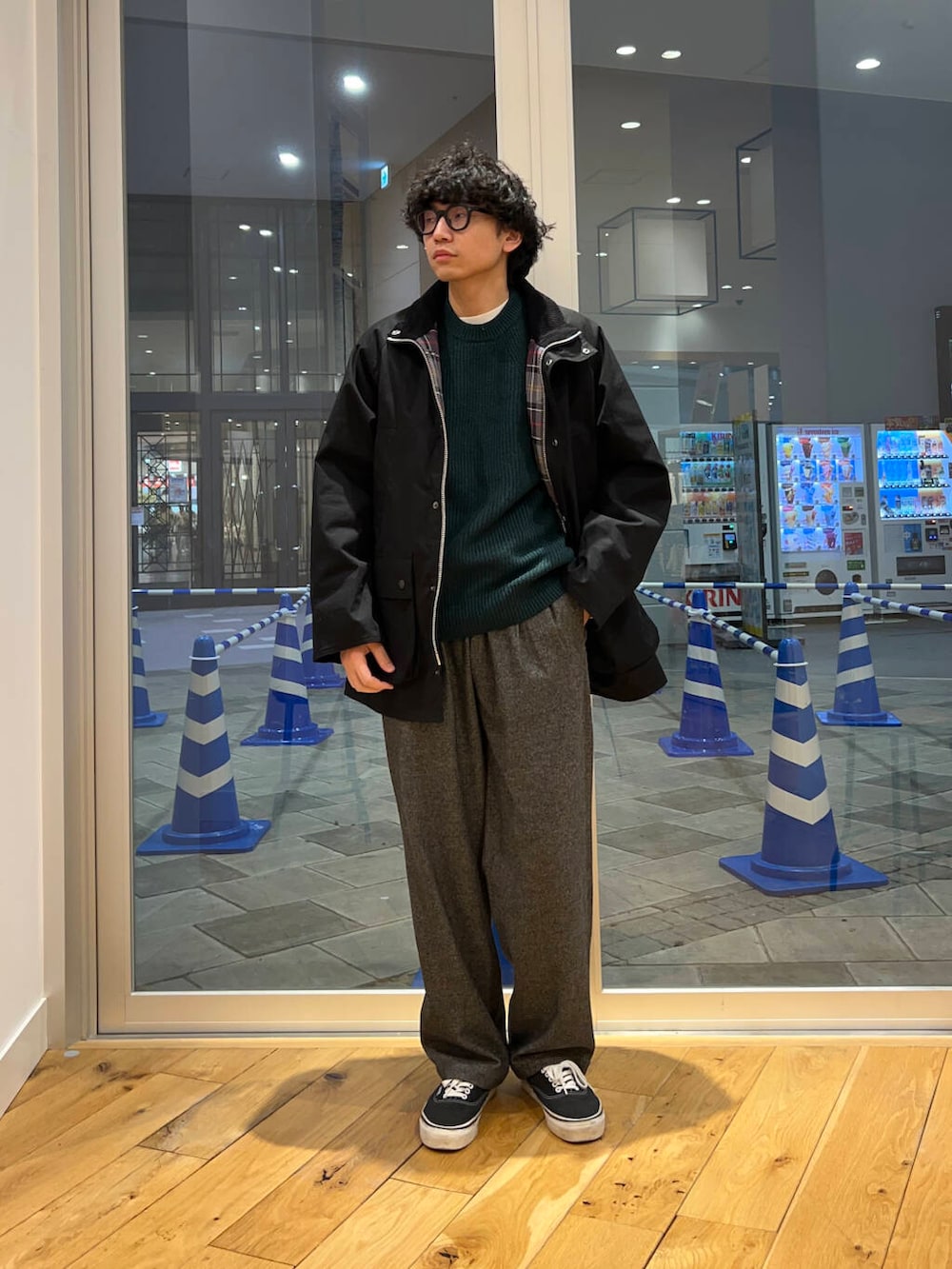 グリーン系のニット/セーター、グレー系のその他パンツ、ブラック系のその他アウターを着用したメンズの冬コーディネートの2枚目の写真