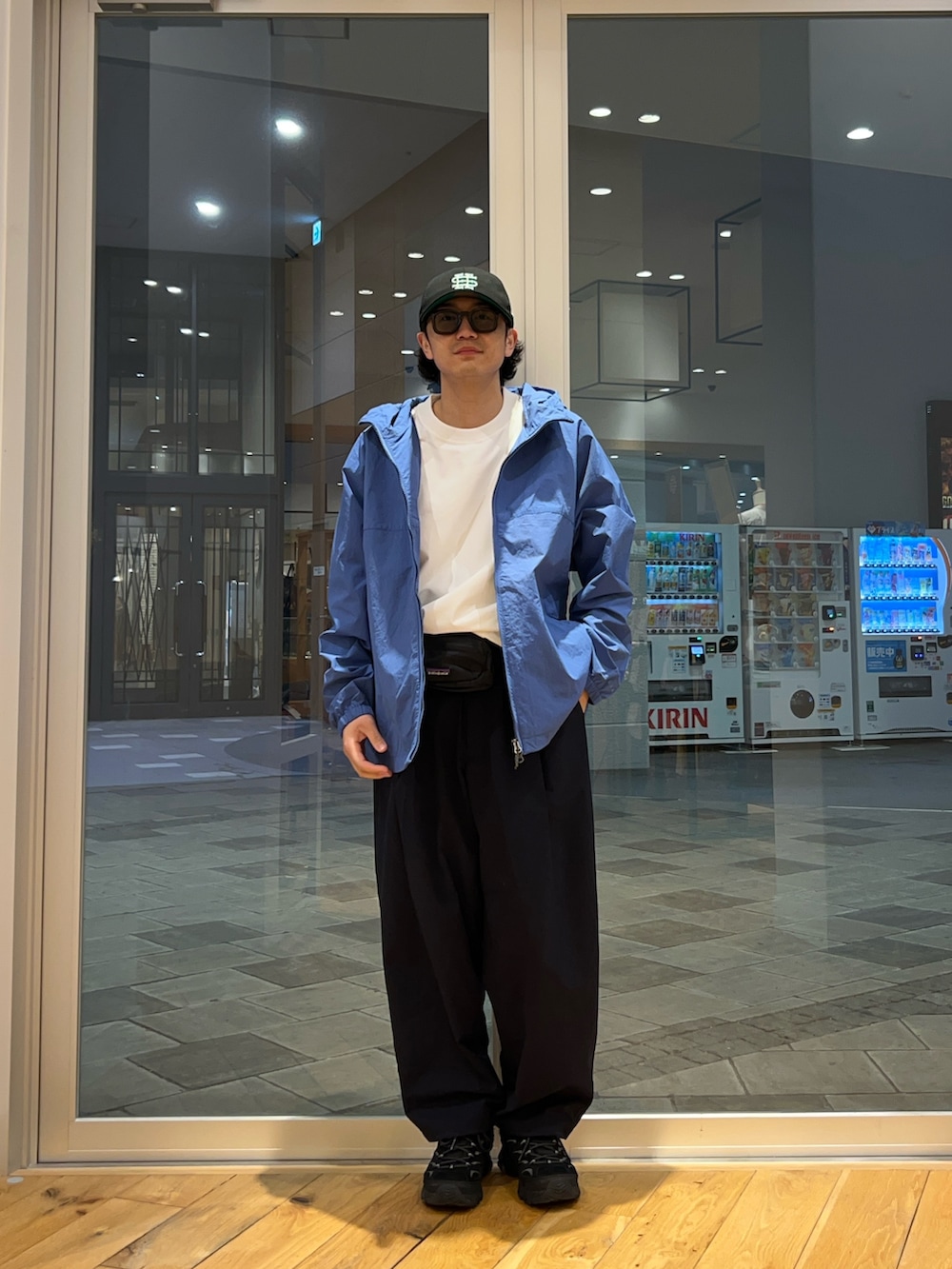 ブルー系のナイロンジャケット、ブルー系のその他パンツ、ホワイト系のTシャツ/カットソーを着用したメンズの春コーディネートの3枚目の写真