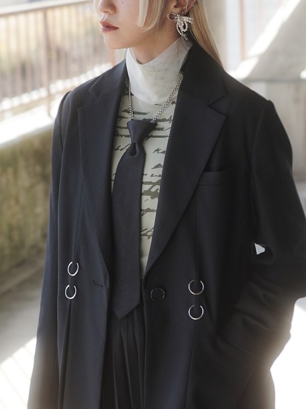 ホワイト系のTシャツ/カットソー、ブラック系のテーラードジャケット、ブラック系のスカートを着用したレディースの春コーディネートの2枚目の写真