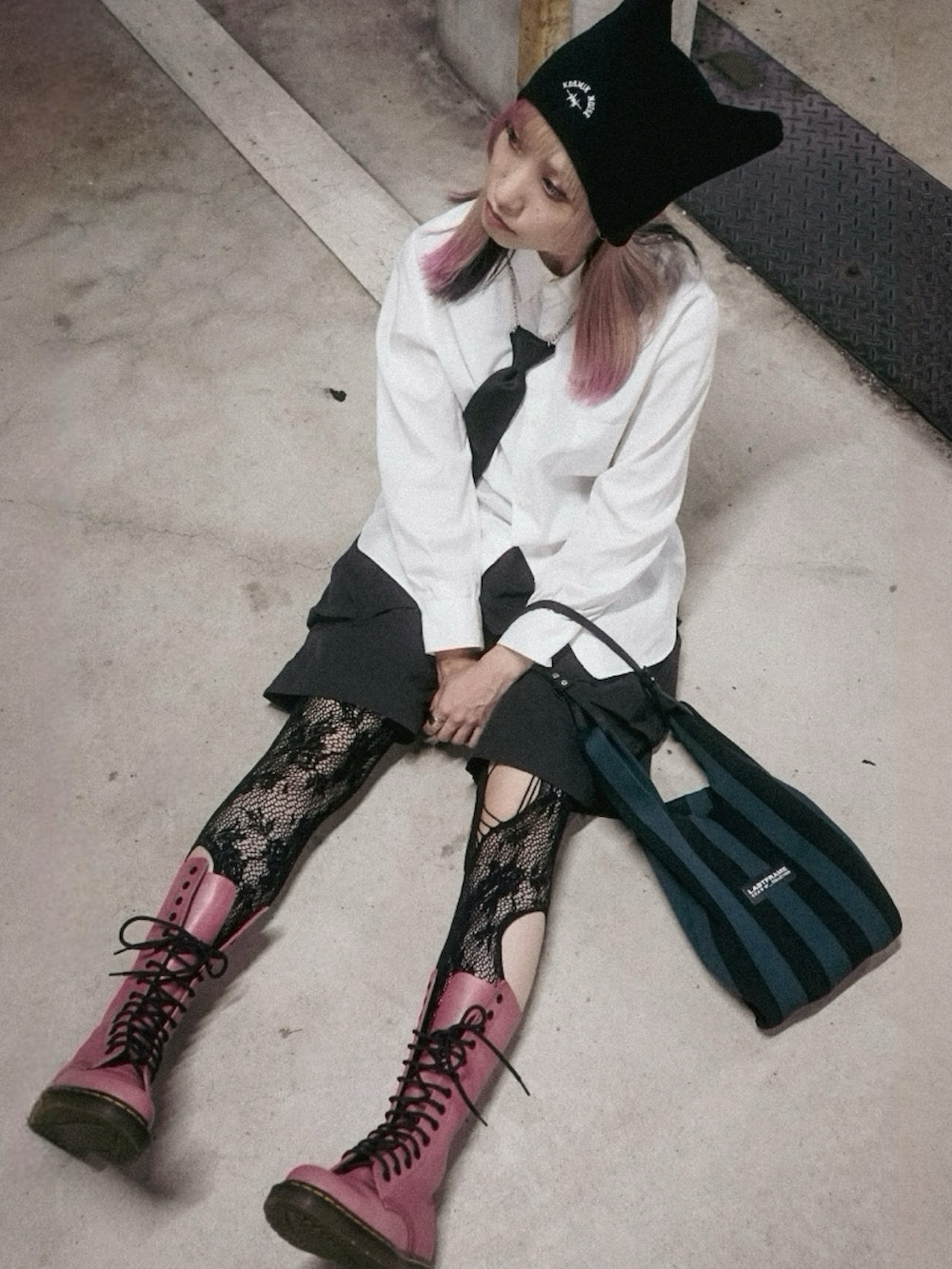 ブラック系のカーゴパンツ、ピンク系のブーツ、ホワイト系のシャツ/ブラウスを着用したレディースの秋コーディネートの3枚目の写真