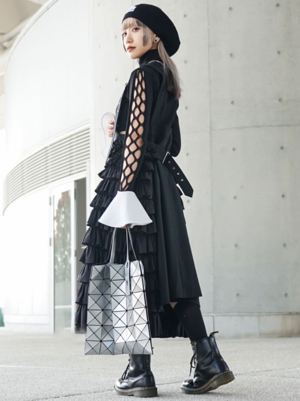 ブラック系のトップス、ブラック系のオールインワン・サロペット、ブラック系のブーツを着用したレディースの春コーディネートの2枚目の写真
