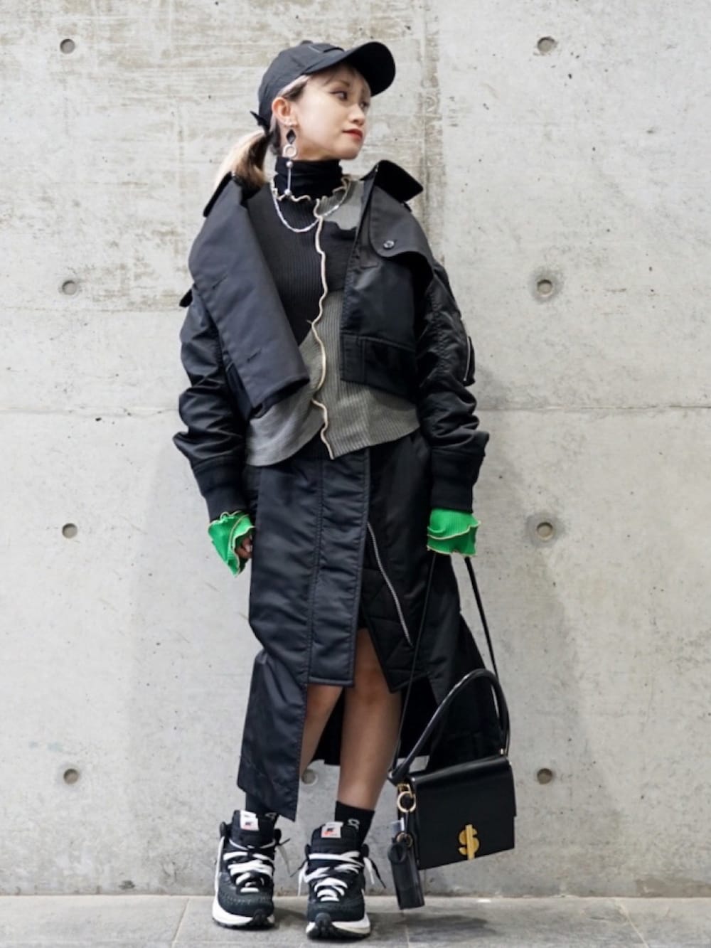 ブラック系のブルゾン、ブラック系のスカート、ブラック系のショルダーバッグを着用したレディースの春コーディネートの2枚目の写真