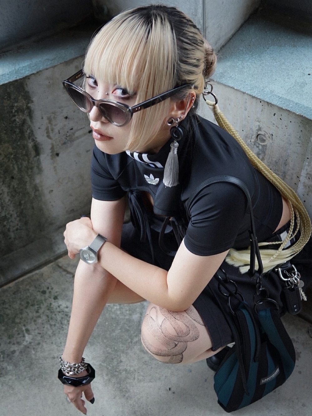 ブラック系のTシャツ/カットソー、ブラック系のスニーカー、グリーン系のショルダーバッグを着用したレディースの秋コーディネートの5枚目の写真