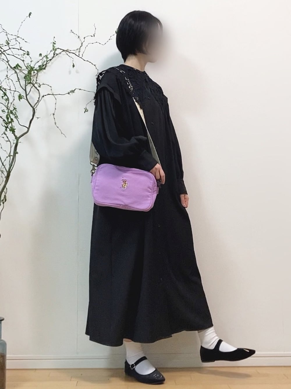 ブラック系のシャツワンピース、パープル系のショルダーバッグ、ブラック系のバレエシューズを着用したレディースの春コーディネートの2枚目の写真