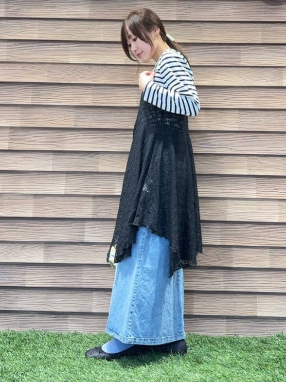 ブラック系のチュニック、ブルー系のTシャツ/カットソー、ブルー系のデニムスカートを着用したレディースの冬コーディネートの2枚目の写真