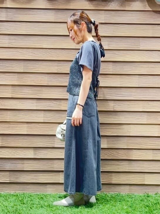 ブラック系のその他トップス、ブラック系のスカート、ゴールド系のパンプスを着用したレディースの春コーディネートの2枚目の写真