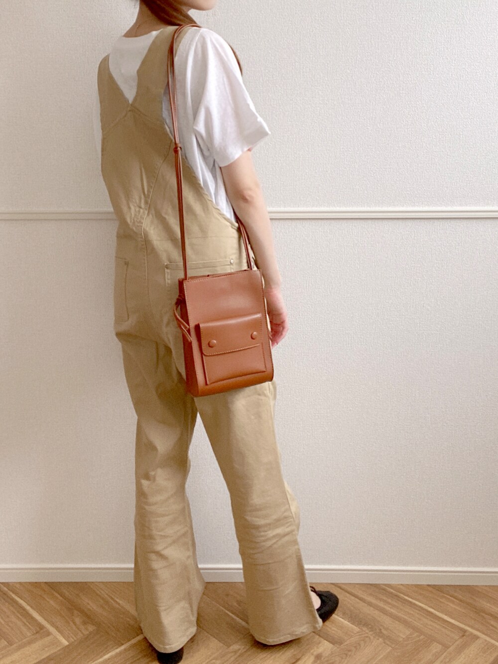 ベージュ系のオールインワン・サロペット、ブラック系のバレエシューズ、ホワイト系のTシャツ/カットソーを着用したレディースの夏コーディネートの3枚目の写真