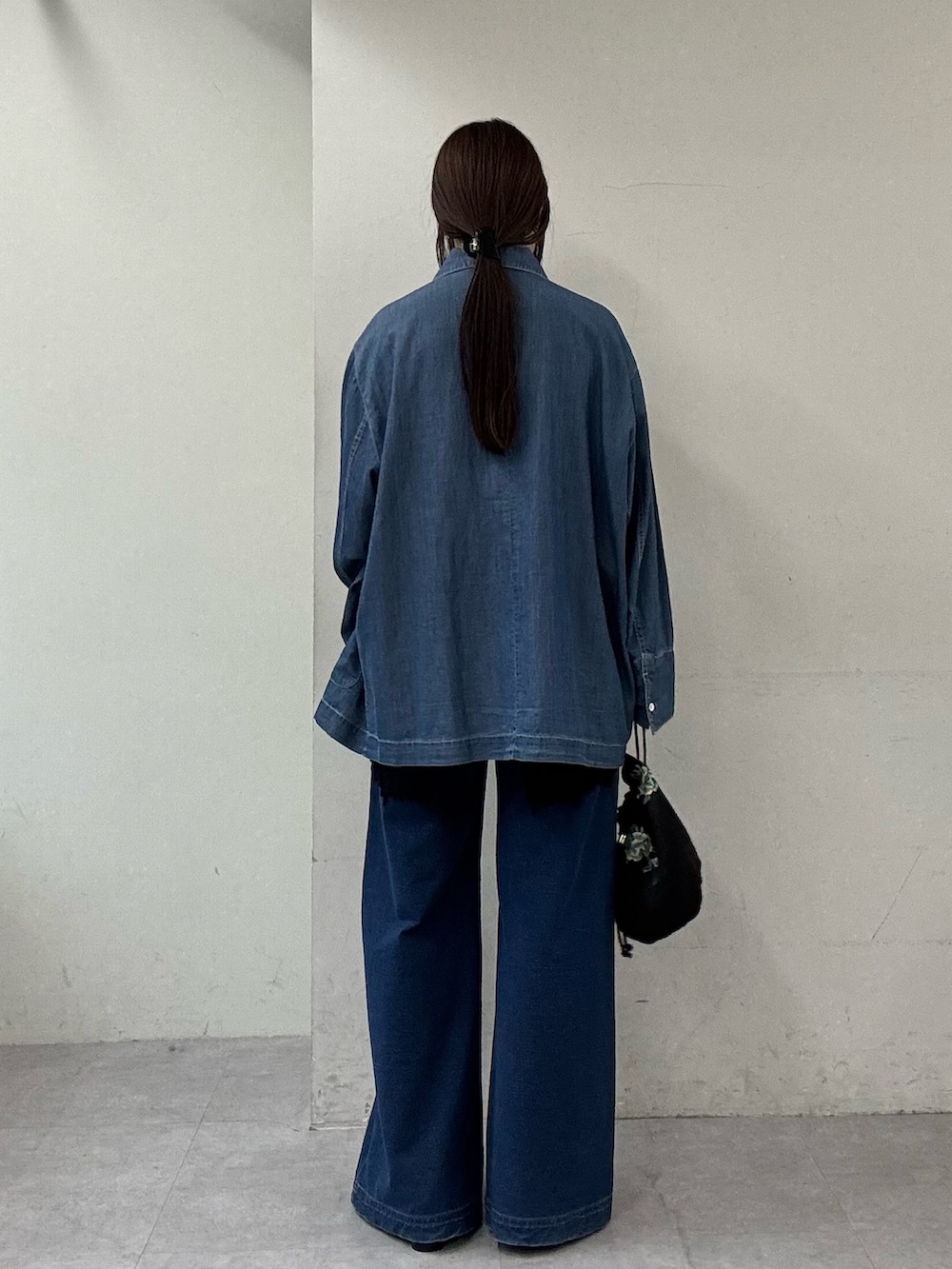 ブルー系のシャツ/ブラウス、ブラック系のキャミソール、ブルー系のデニムパンツを着用したレディースの春コーディネートの3枚目の写真