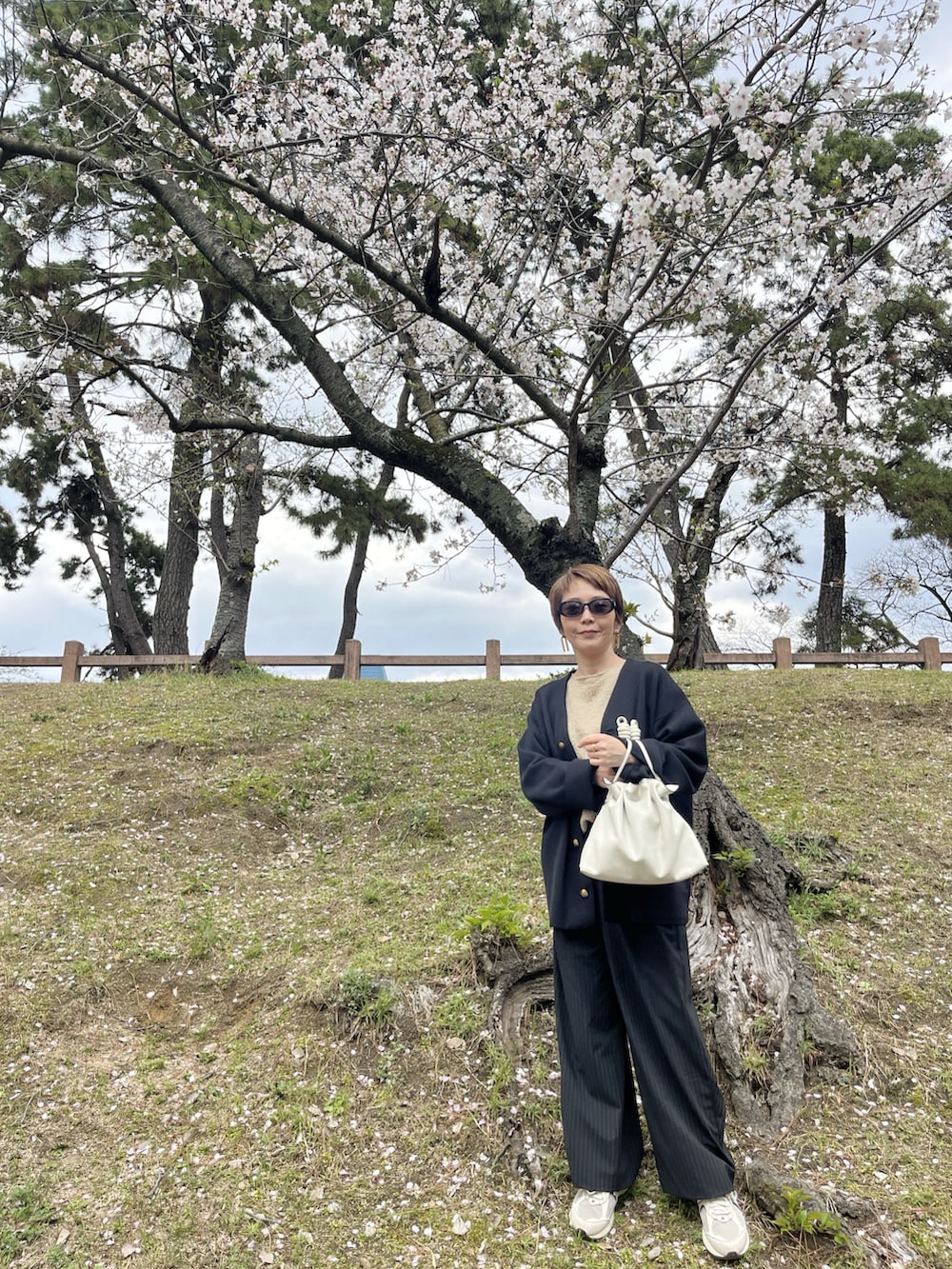 ブラック系のニット/セーター、ベージュ系のニット/セーター、その他のその他パンツを着用したレディースの春コーディネートの2枚目の写真