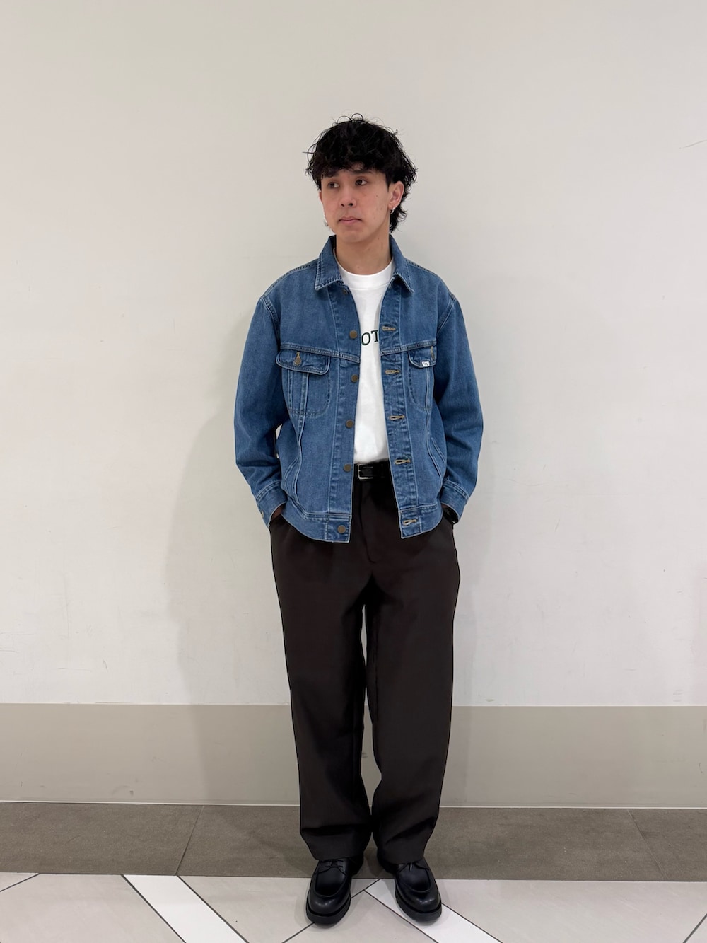 ブラウン系のその他パンツ、ブルー系のデニムジャケット、ブラック系のドレスシューズを着用したメンズの春コーディネートの4枚目の写真