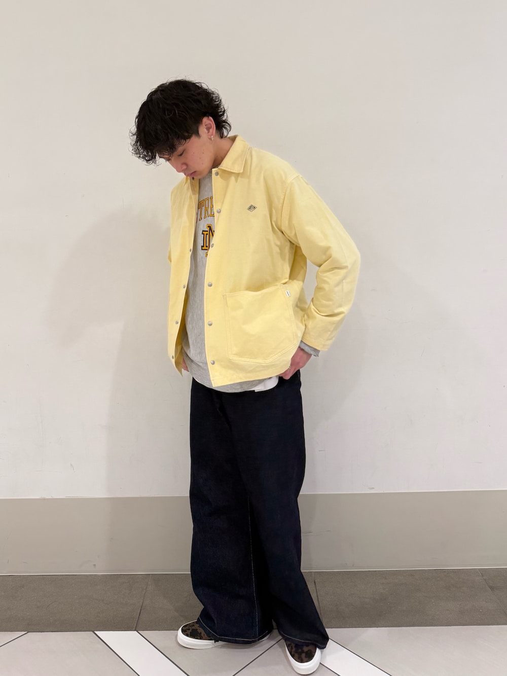 ブラウン系のスニーカー、ブルー系のデニムパンツを着用したメンズの春コーディネートの4枚目の写真