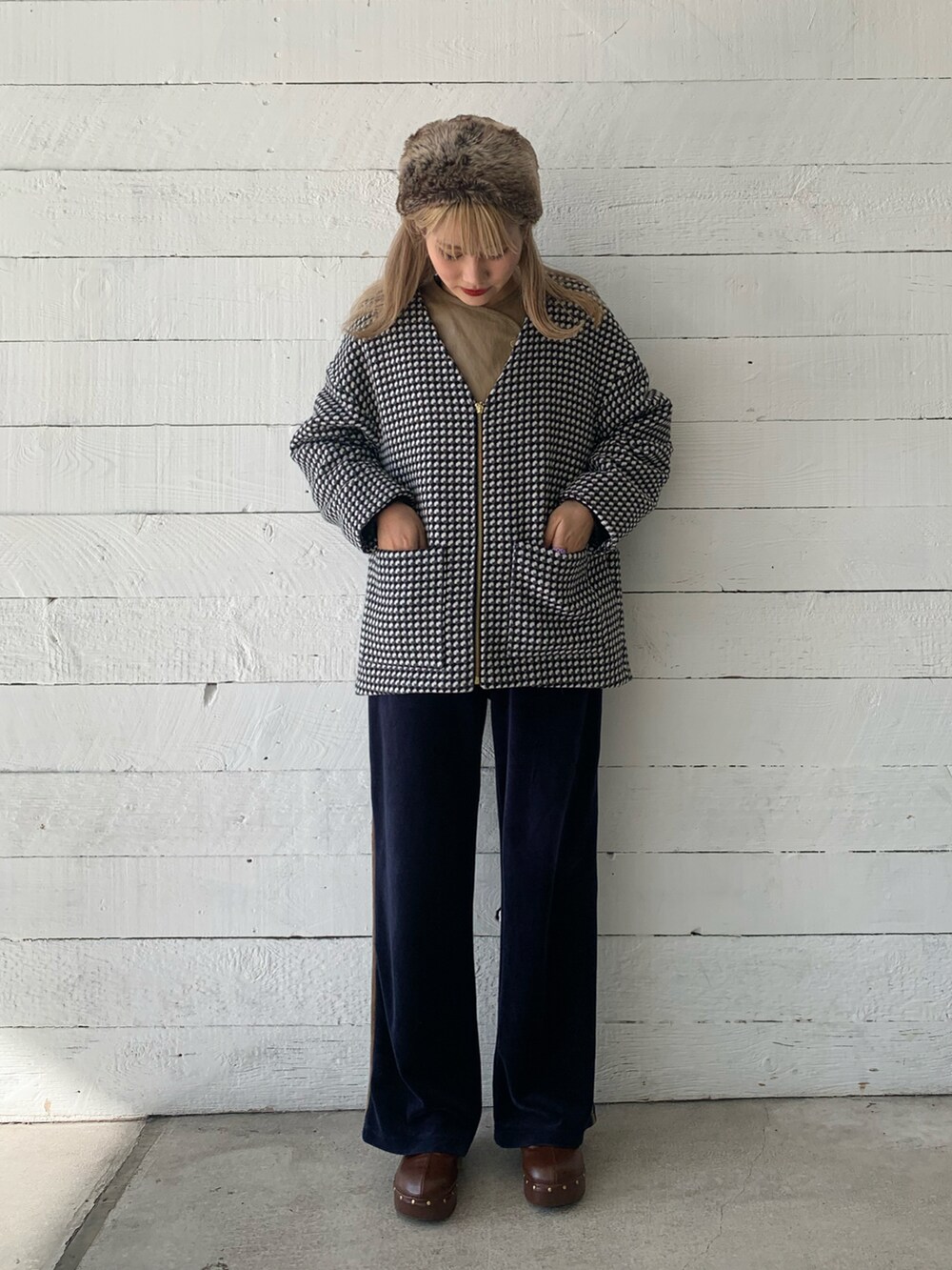 ブラック系のノーカラーコートを着用したレディースの秋コーディネートの4枚目の写真