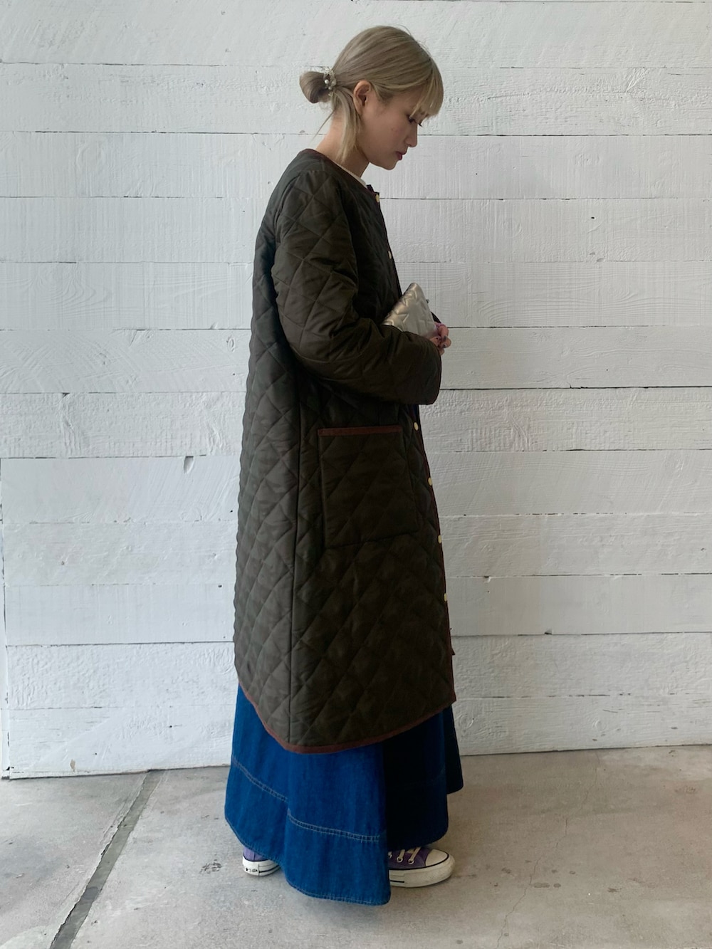 ブラック系のジャンパースカート、ホワイト系のニット/セーターを着用したレディースの秋コーディネートの2枚目の写真