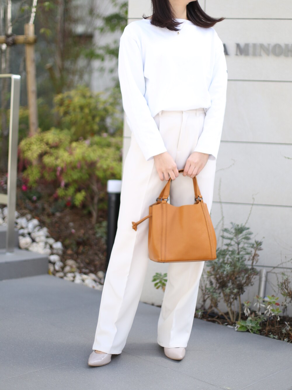 イエロー系のハンドバッグを着用したレディースの夏コーディネートの2枚目の写真