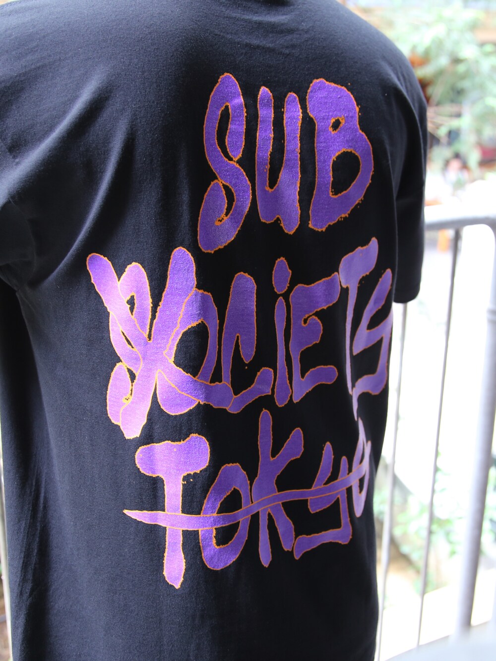 ブラック系のTシャツ/カットソー、ブラック系のその他パンツ、オレンジ系のサングラスを着用したメンズの春コーディネートの2枚目の写真