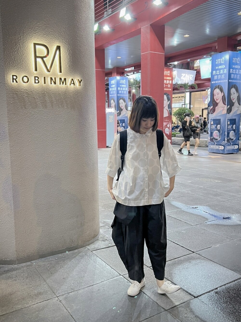 ブラック系のスラックス、ホワイト系のシューズを着用したレディースの秋コーディネートの2枚目の写真