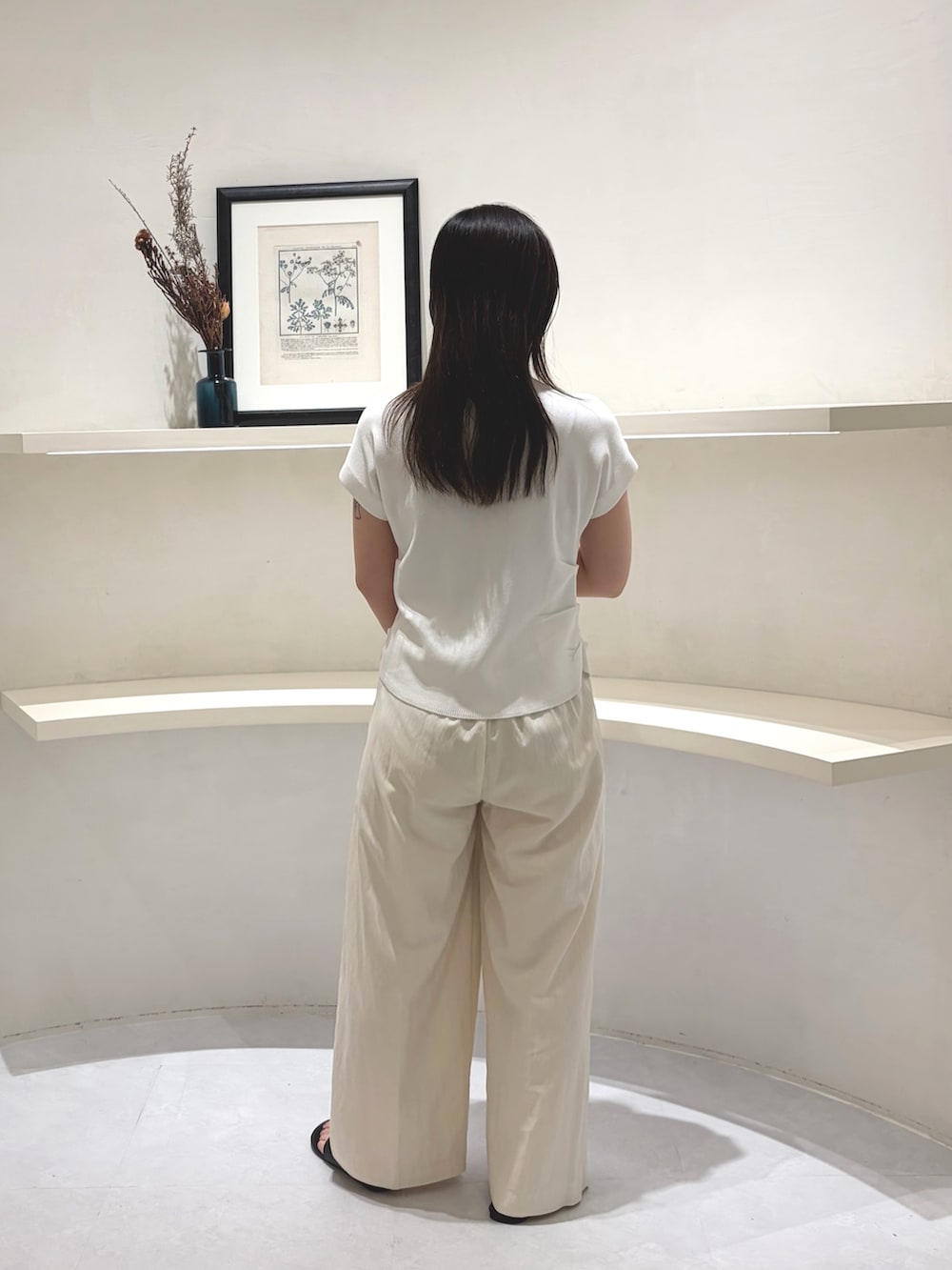 ブラック系のパンプス、ブラック系のショルダーバッグ、ホワイト系のその他パンツを着用したレディースの夏コーディネートの3枚目の写真