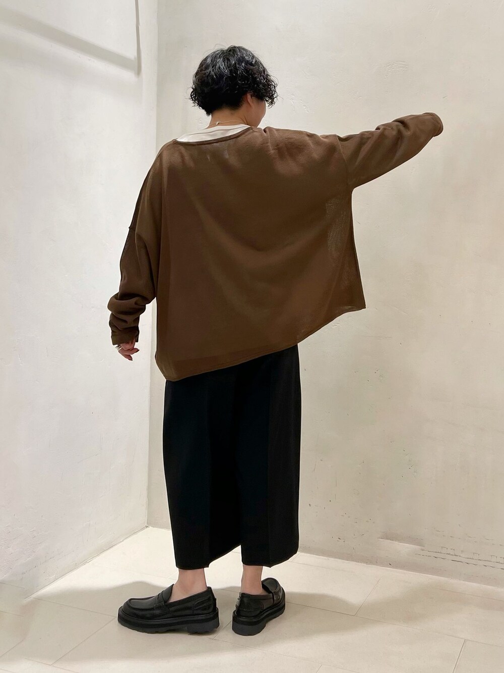ブラック系のその他パンツ、ホワイト系のTシャツ/カットソー、ブラウン系のニット/セーターを着用したレディースの春コーディネートの4枚目の写真