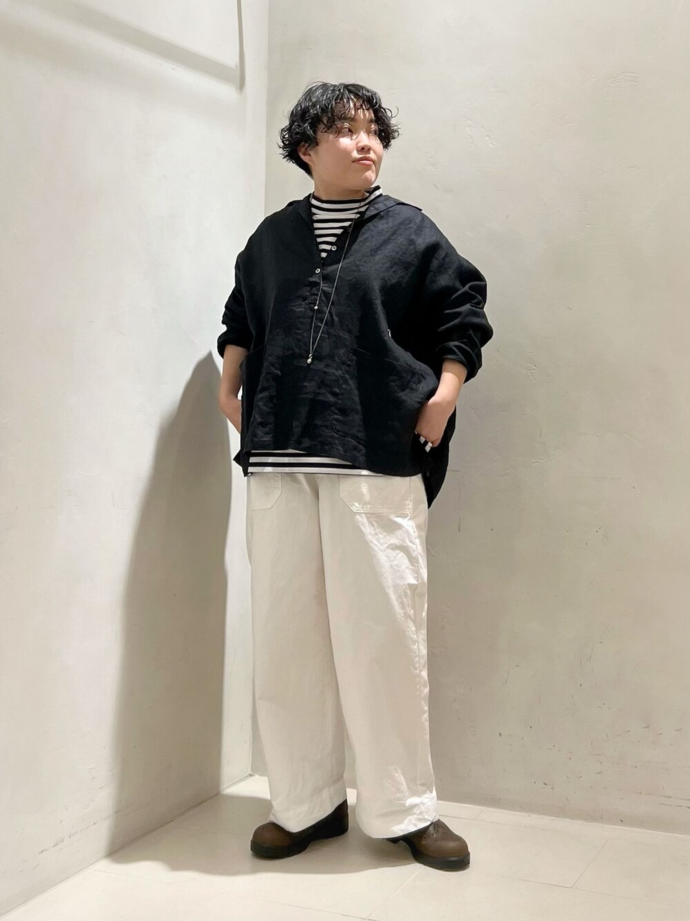 ホワイト系のその他パンツ、ブラック系のシャツ/ブラウス、ブラック系のTシャツ/カットソーを着用したレディースの春コーディネートの3枚目の写真