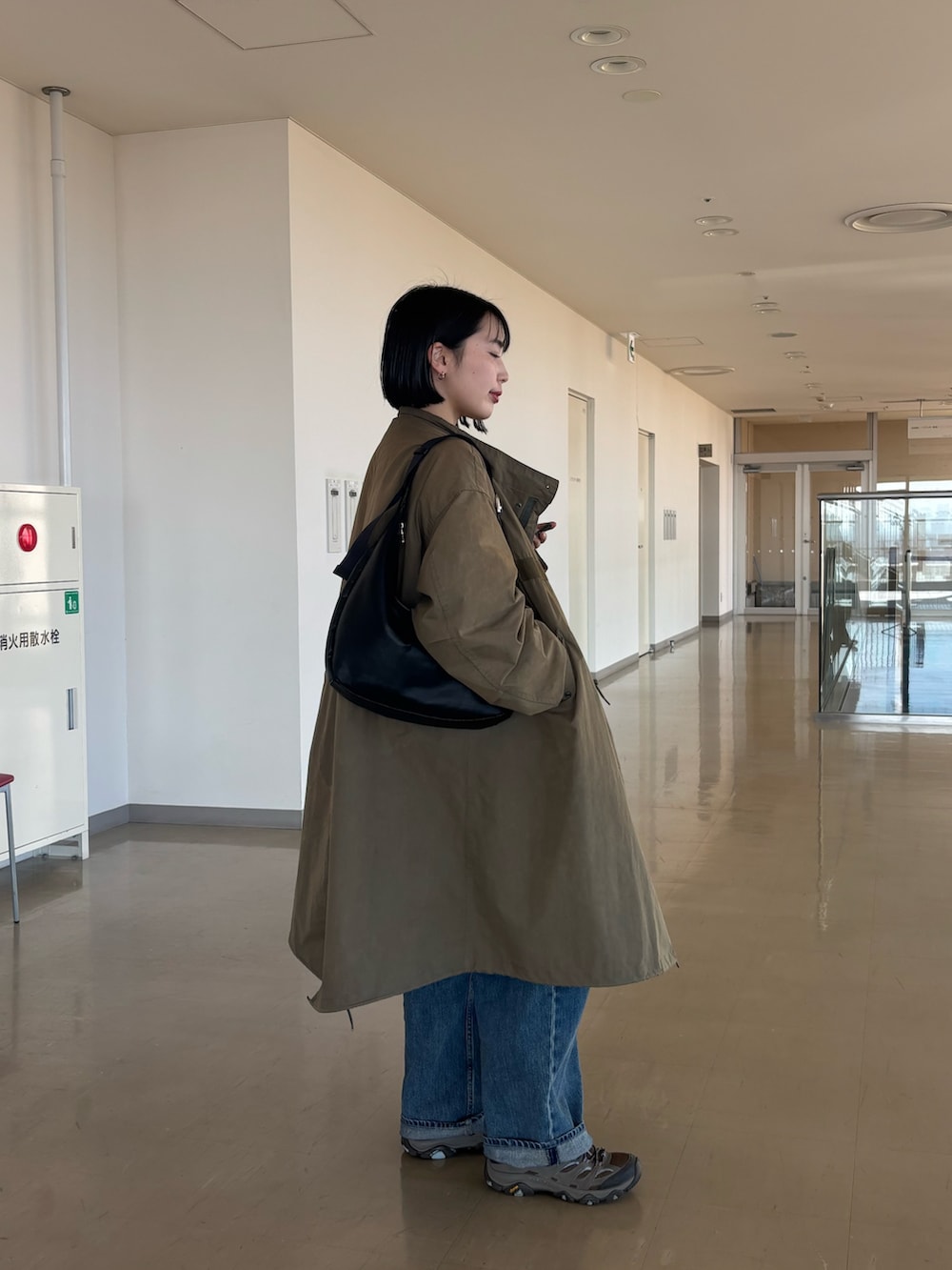 ブラック系のショルダーバッグを着用したレディースの冬コーディネートの3枚目の写真