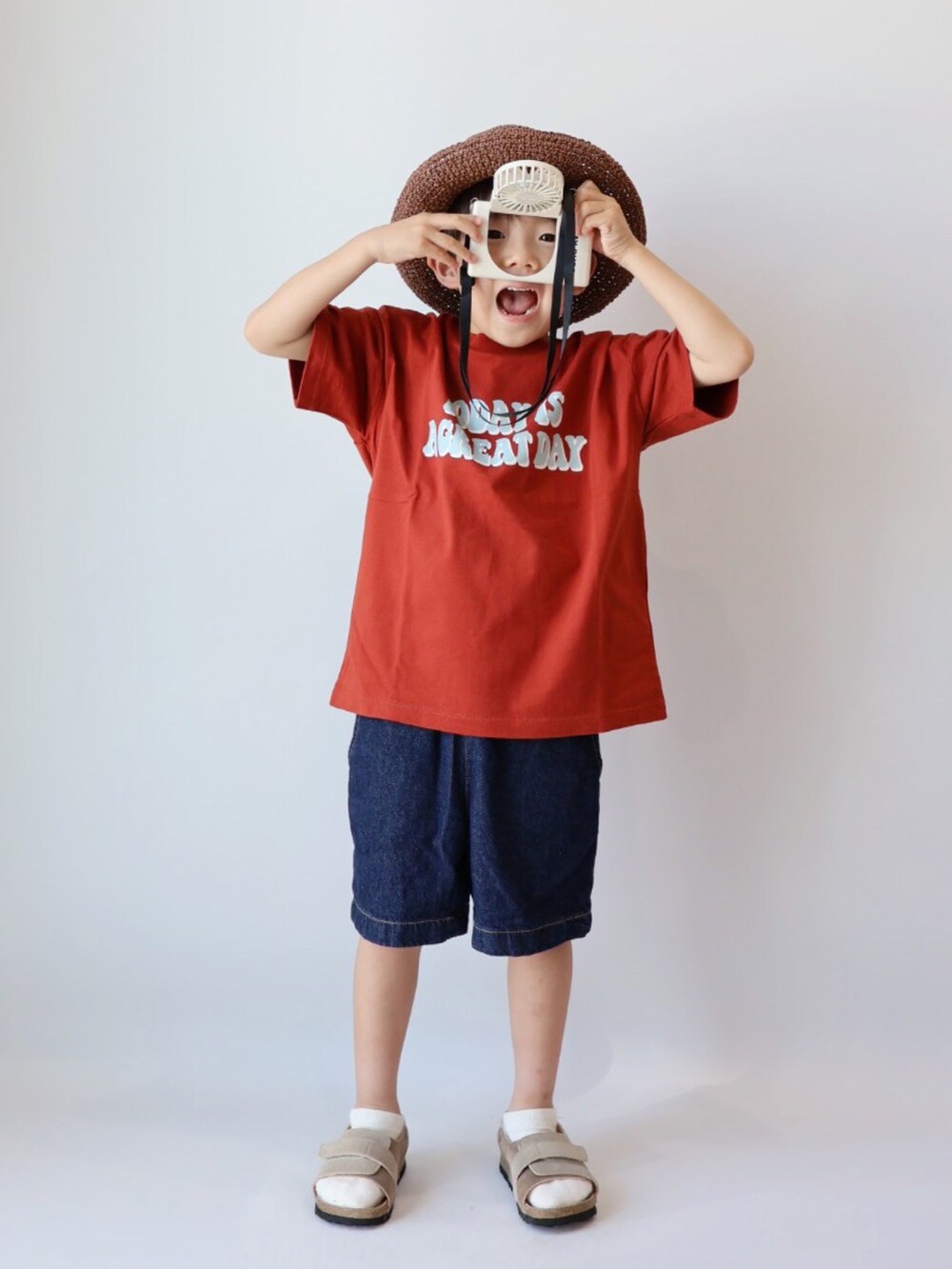 レッド系のTシャツ/カットソー、ブルー系のパンツ、ベージュ系のサンダルを着用したキッズの夏コーディネートの5枚目の写真