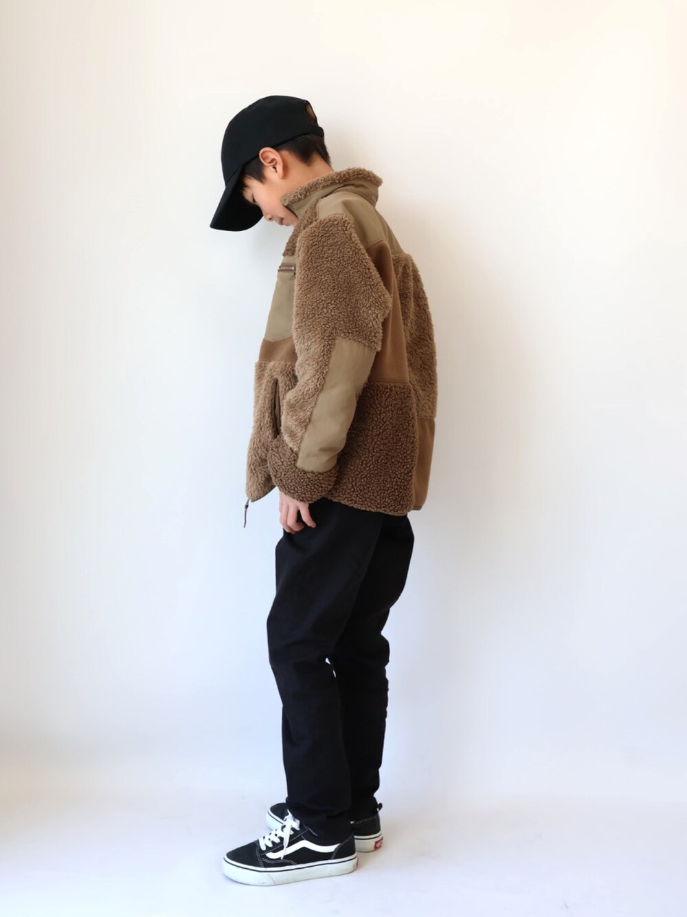 ホワイト系のTシャツ/カットソー、ベージュ系のジャケット/アウター、ブラック系のパンツを着用したキッズの冬コーディネートの3枚目の写真