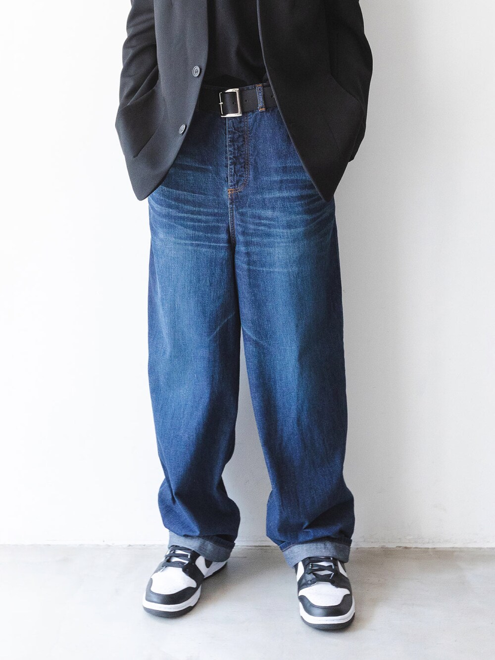 ブルー系のデニムパンツ、ブラック系のノーカラージャケット、ブラック系のベルトを着用したメンズの夏コーディネートの2枚目の写真