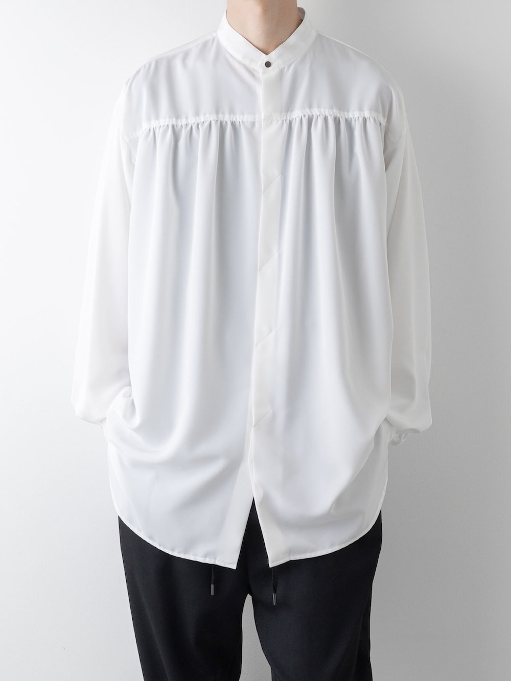 ブラック系のその他パンツ、ホワイト系のシャツ/ブラウス、ブルー系のニット/セーターを着用したメンズの秋コーディネートの4枚目の写真