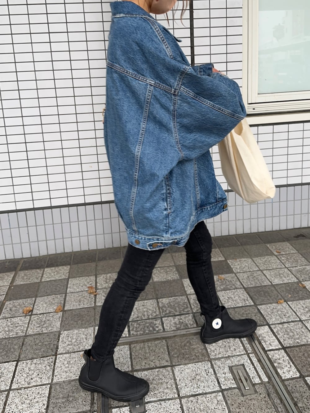 ブルー系のデニムジャケット、ブルー系のTシャツ/カットソー、ブラック系のデニムパンツを着用したレディースの春コーディネートの3枚目の写真