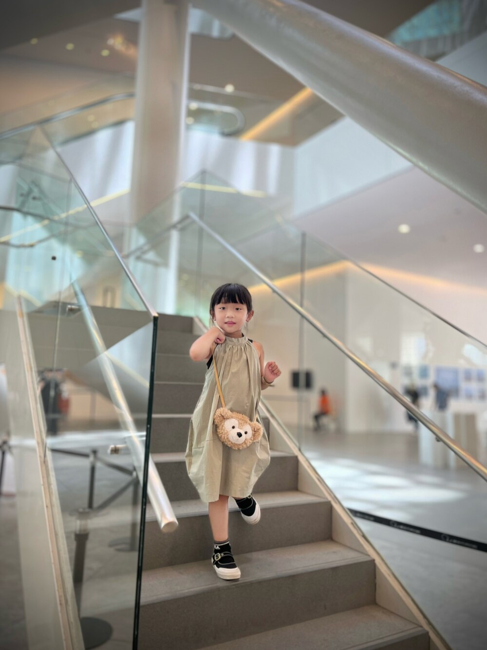 グリーン系のワンピース、ブラック系のスニーカー、グリーン系のヘアアクセサリーを着用したレディースの夏コーディネートの2枚目の写真