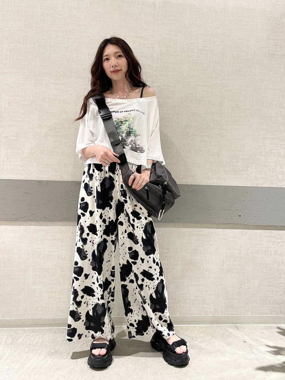 ブラック系のその他パンツ、グレー系のショルダーバッグ、ホワイト系のTシャツ/カットソーを着用したレディースの夏コーディネートの2枚目の写真