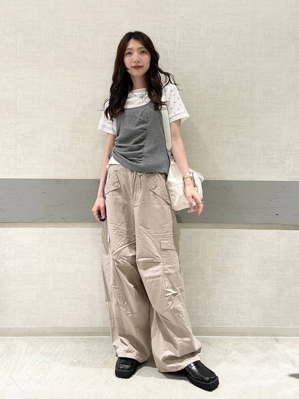 ブラック系のローファー、ホワイト系のTシャツ/カットソー、ホワイト系のトートバッグを着用したレディースの夏コーディネートの3枚目の写真