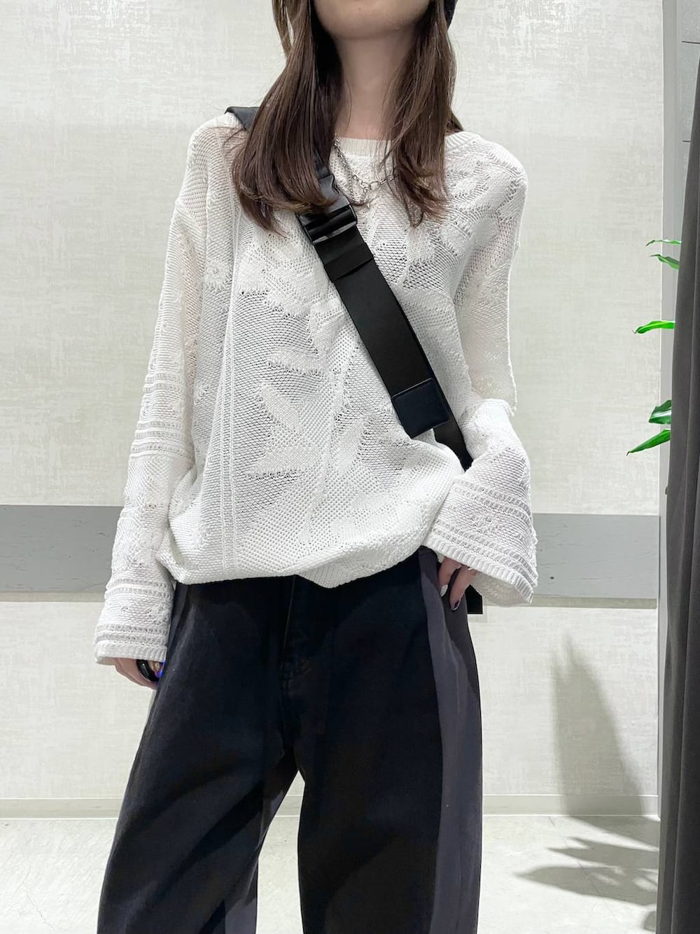 ブラック系のショルダーバッグ、ブラック系のその他シューズ、ブラック系のデニムパンツを着用したレディースの冬コーディネートの5枚目の写真