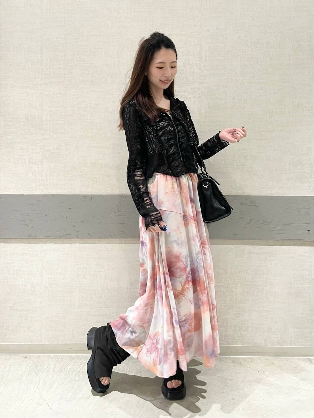 ブラック系のボストンバッグ、ブラック系のサンダル、ブラック系のパーカーを着用したレディースの春コーディネートの2枚目の写真