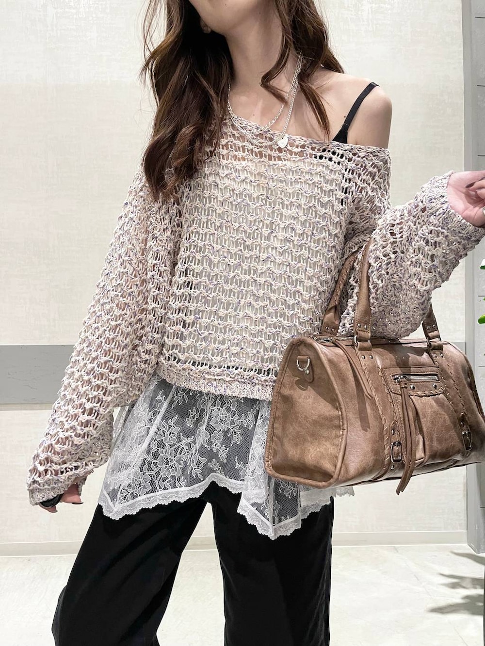 ブラック系のローファー、ブラック系のボストンバッグ、ブラック系のデニムパンツを着用したレディースの春コーディネートの6枚目の写真